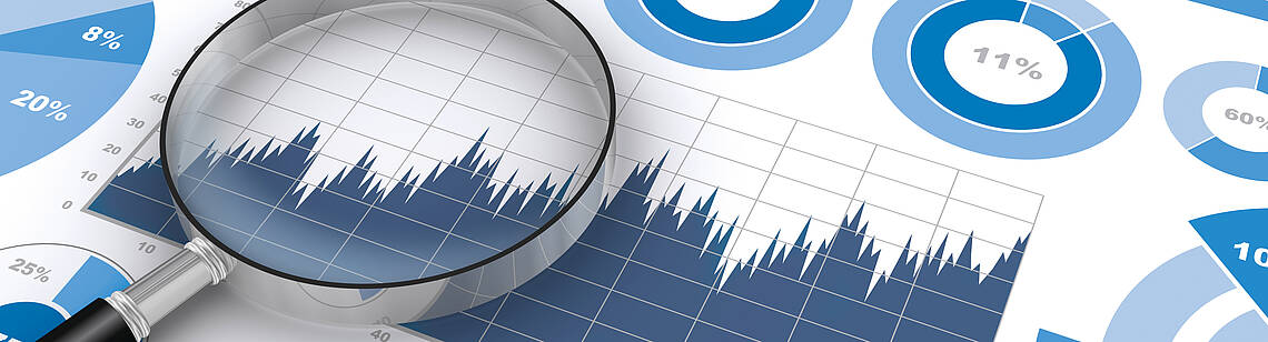 Lupe auf einem Blatt mit verschiedenen Diagrammtypen